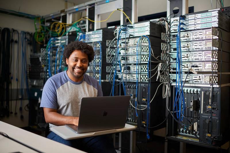 A GVSU computer science student in a technology lab.